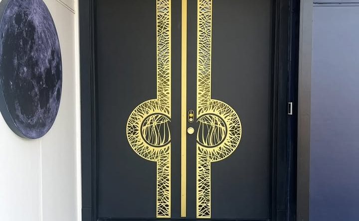 Luxury custom front door with brass and aluminum detailing in Bothell, WA